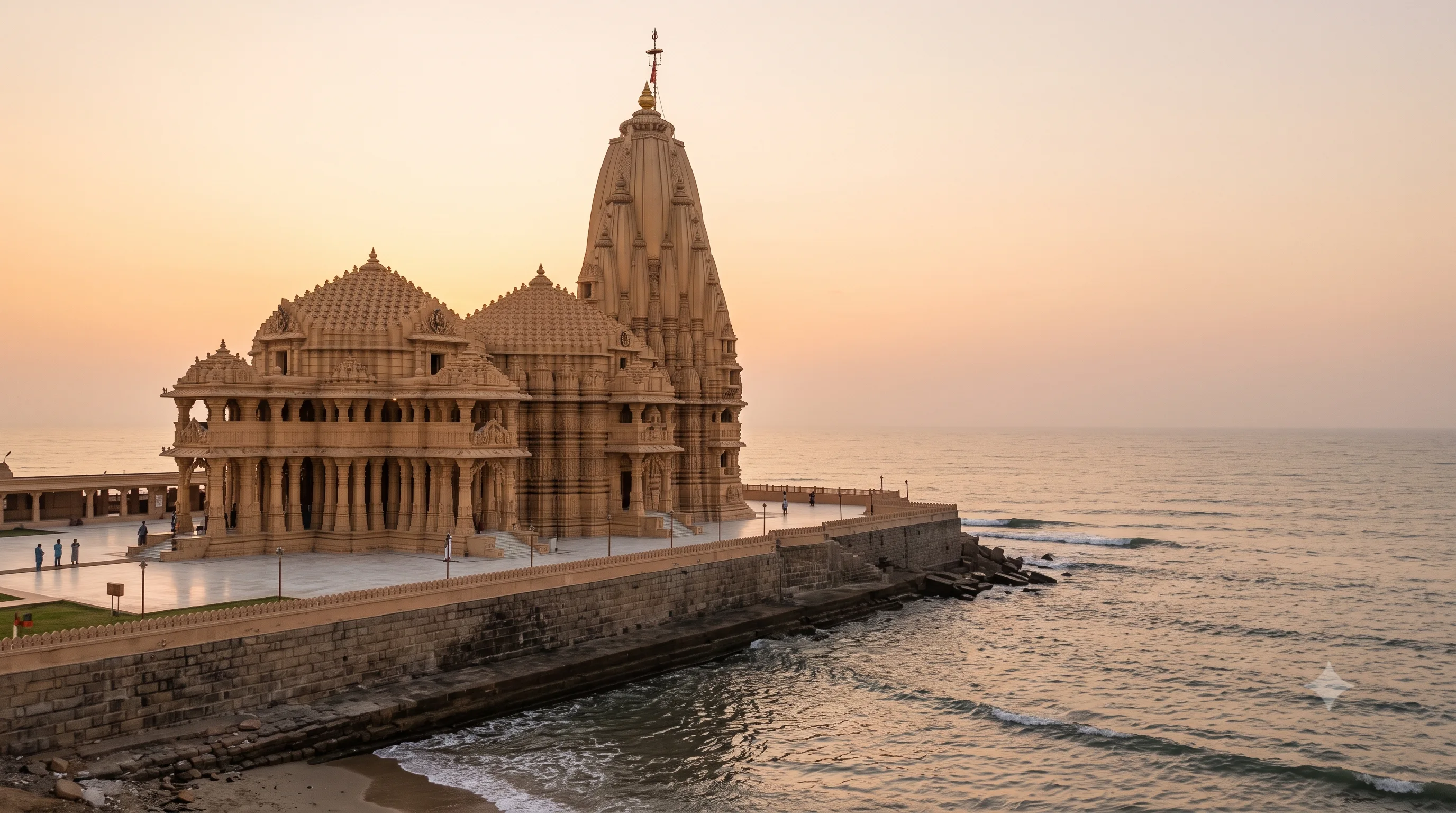 Somnath temple's sandstone shikhara rising beside the Arabian Sea at dusk